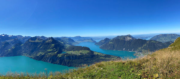 Scenic view of mountains against clear blue sky