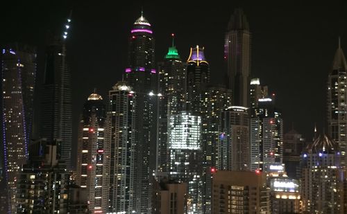 Low angle view of skyscrapers lit up at night