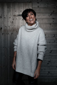 Portrait of a smiling young man standing against wall