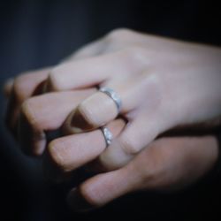 Close-up of woman hand over black background