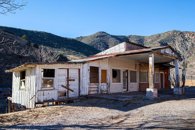 Exterior of abandoned building against clear blue sky