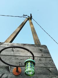 Low angle view of lantern hanging against clear sky