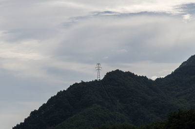 Low angle view of lighthouse and buildings against sky