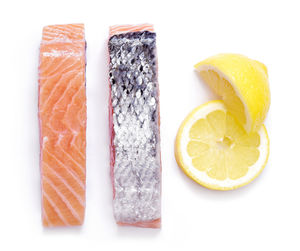 Close-up of fish served on white background