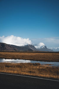 Scenic view of landscape against blue sky