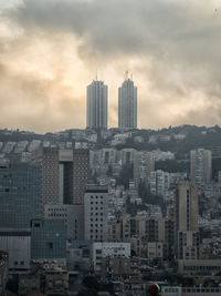 Cityscape against cloudy sky