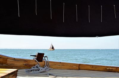 Sailboat sailing on sea against sky