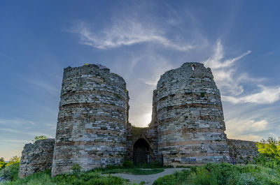 Low angle view of old ruin building against sky