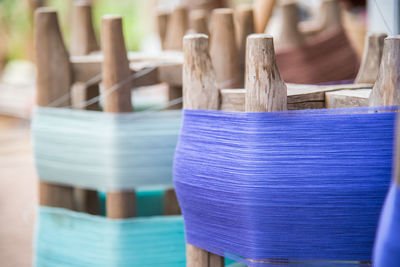 Close-up of threads rolled on wooden equipment