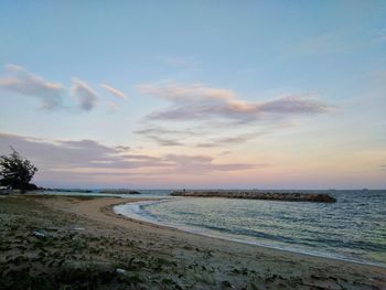 Scenic view of beach against sky during sunset