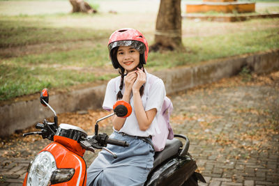 Side view of boy riding bicycle on field