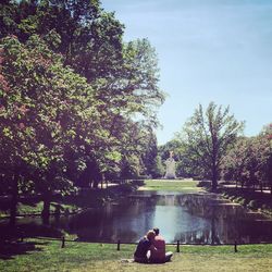 Rear view of man relaxing on lake