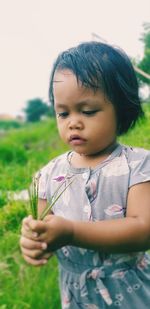Cute girl looking away on field