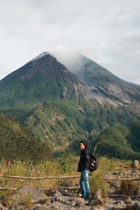 Full length of man standing on mountain against sky