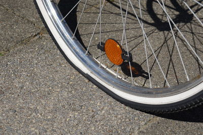 Close-up of punctured bicycle wheel on street