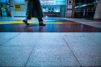 Low section of man walking on footpath