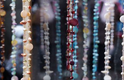 Various necklaces hanging at market stall