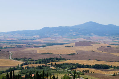 Scenic view of landscape and mountains against clear sky