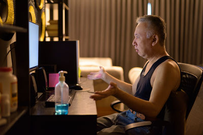 Side view of man using mobile phone