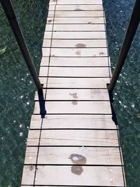 Low section of person standing by swimming pool