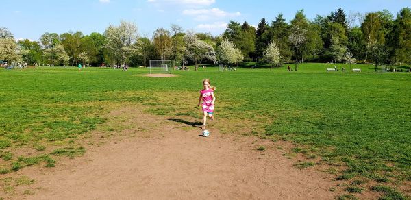 Full length of woman on field against trees