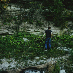 Rear view of man walking in forest