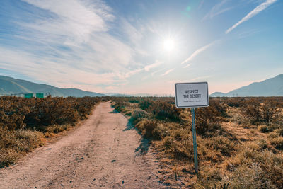 High angle view of road sign against sky