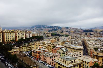 High angle view of cityscape against cloudy sky