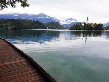 Scenic view of swimming pool by lake against sky