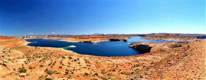 Scenic view of bay against clear blue sky