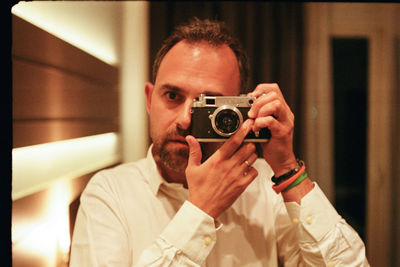 Young woman photographing with camera