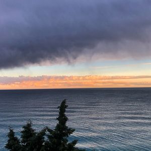 Scenic view of sea against sky at sunset