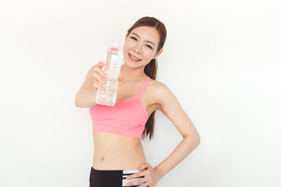 Athlete holding water bottle against white background