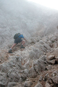 Man standing on rock against mountains