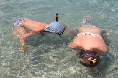 High angle view of women swimming in sea
