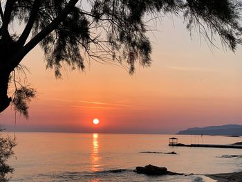 Scenic view of sea against romantic sky at sunset