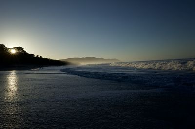 Scenic view of sea against clear sky during sunset