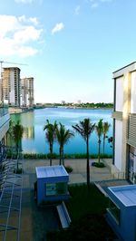 Swimming pool by sea against sky in city