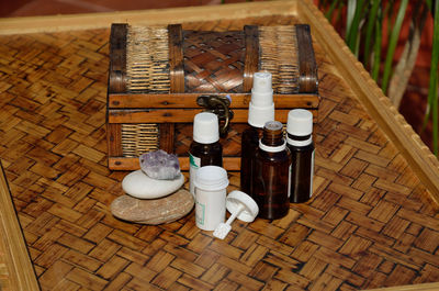 High angle view of bottles in basket on table