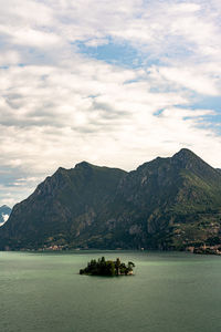 Scenic view of sea and mountains against sky