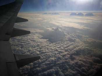 Aerial view of airplane wing against sky