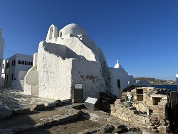 Low angle view of buildings against clear blue sky
