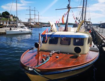 Sailboats moored in marina