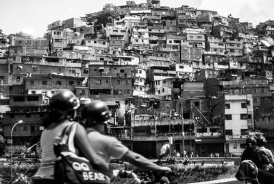 People in city against buildings