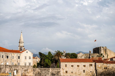 Buildings in city against sky