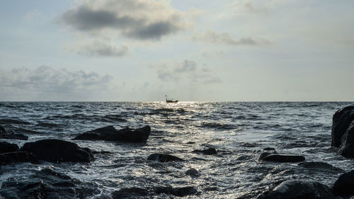 View of calm sea against cloudy sky