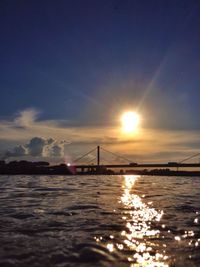 Bridge over river at sunset