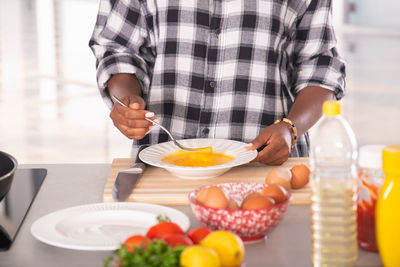 Midsection of man preparing food