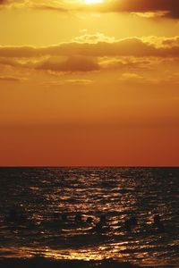 Scenic view of sea against orange sky