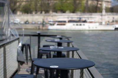 Chairs and tables by river